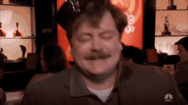 Nick Offerman as Ron Swanson dancing happily